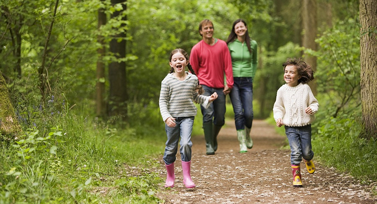 Family-Walking-On-Path-Holding-Hands