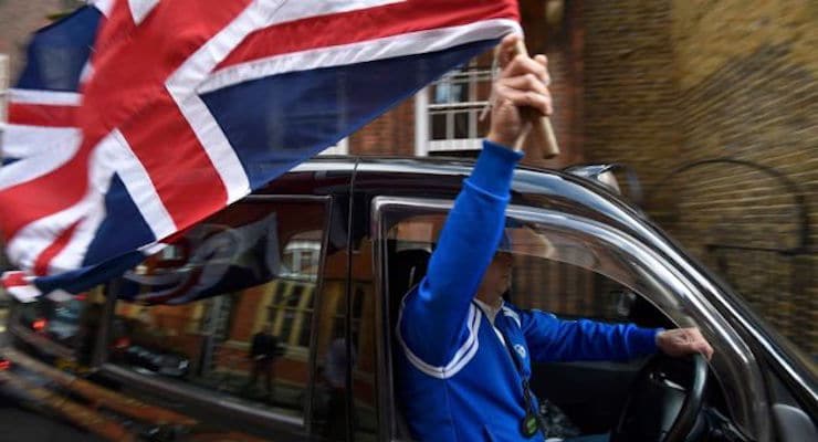 Taxi driver waves Union Flag. (Photo: Reuters)