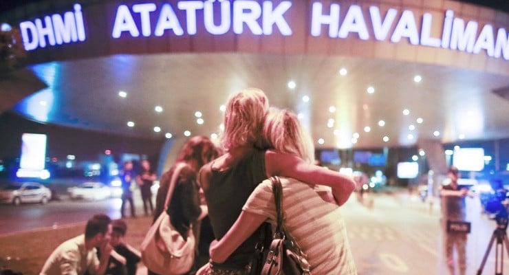 Passengers embrace each other at the entrance to Istanbul's Ataturk airport, early Wednesday, June 29, 2016 following their evacuation after a blast. Suspected Islamic State group extremists have hit the international terminal of Istanbul's Ataturk airport, killing dozens of people and wounding many others, Turkish officials said Tuesday. Turkish authorities have banned distribution of images relating to the Ataturk airport attack within Turkey. (AP Photo/Emrah Gurel)