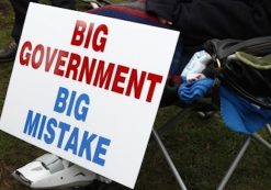 A protestor rests next to their big government big mistake sign. (Photo: Reuters)