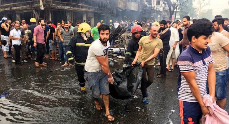 July 3, 2016: Iraqi firefighters and civilians carry bodies of victims killed in a car bomb at a commercial area in Karada neighborhood, Baghdad, Iraq. (Photo: Associated Press/AP)