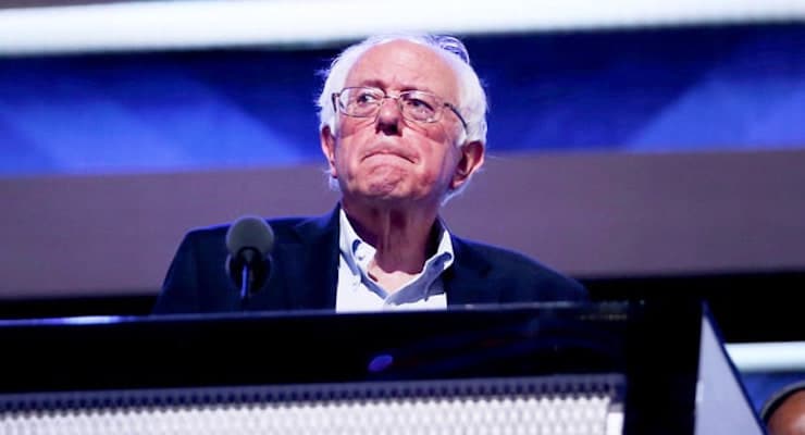 Bernie Sanders stands at the podium on stage during a walk through before the start of the Democratic National Convention in Philadelphia, Pennsylvania on July 25, 2016.