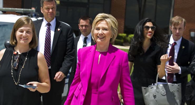 Democratic presidential candidate Hillary Clinton, followed by aide Huma Abedin, second from right, walks on the tarmac as she arrives to board Air Force One at Andrews Air Force Base, Md., Tuesday, July 5, 2016. President Barack Obama and Clinton are traveling to Charlotte, N.C. to campaign together. ( AP Photo/Jose Luis Magana)