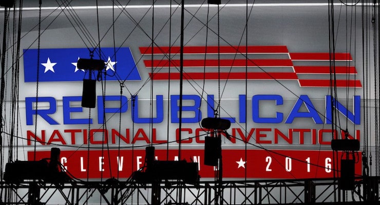 A Republican National Convention logo is seen though silhouetted production equipment on a huge video screen at Quicken Loans Arena for the Republican National Convention, Sunday, July 17, 2016, in Cleveland. (AP Photo/Carolyn Kaster)