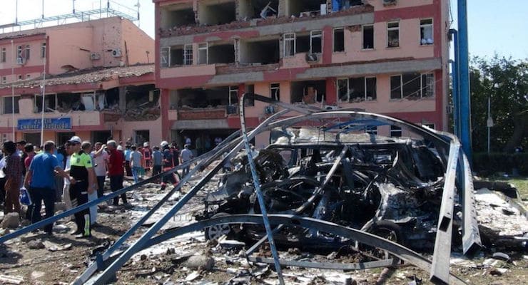 Aug. 18, 2016: Turkish authorities search outside the damaged building of the police headquarters after an explosion in Elazig, eastern Turkey. (Sahismail Gezici/DHA via AP)