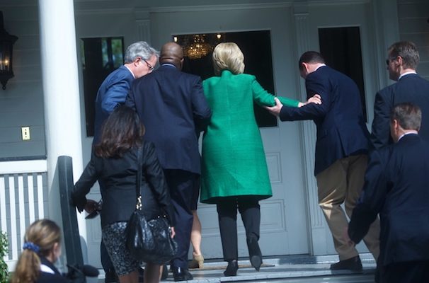 Democratic presidential candidate Hillary Clinton is helped up stairs in a photo captured by Reuters. (PHOTO: REUTERS)