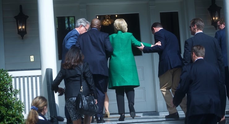 Democratic presidential candidate Hillary Clinton is helped up stairs in a photo captured by Reuters. (PHOTO: REUTERS)