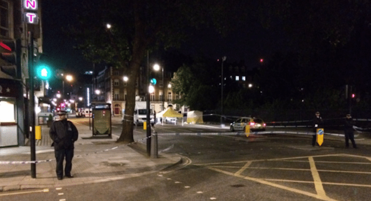 A police officers stands watch by the forensics tent set up next to the park in Russell Square in central London, near the British Museum.