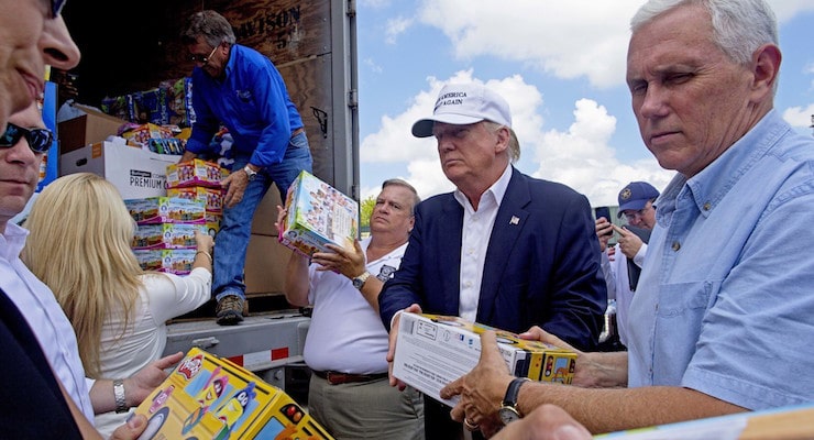 Republican presidential candidate Donald Trump and his running mate, Indiana Gov. Mike Pence, right, help to unload supplies for flood victims during a tour of the flood damaged area in Gonzales, La., on Friday. (Photo: AP)