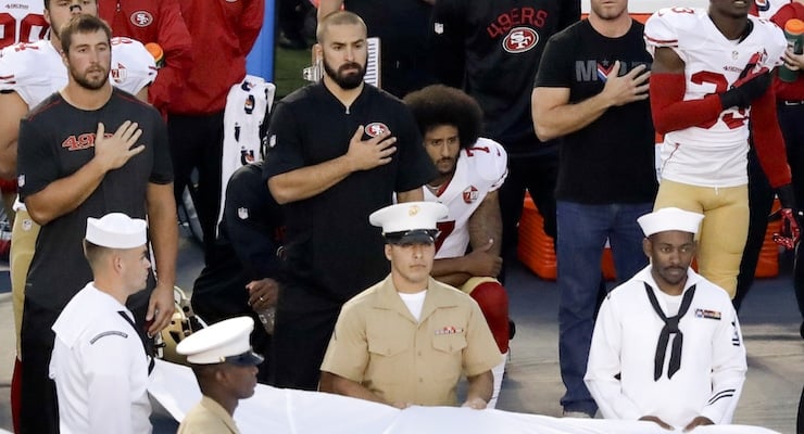 San Francisco 49ers quarterback Colin Kaepernick, middle, sits during the National Anthem before an NFL preseason football game against the San Diego Chargers, Thursday, Sept. 1, 2016, in San Diego. (AP Photo/Chris Carlson)