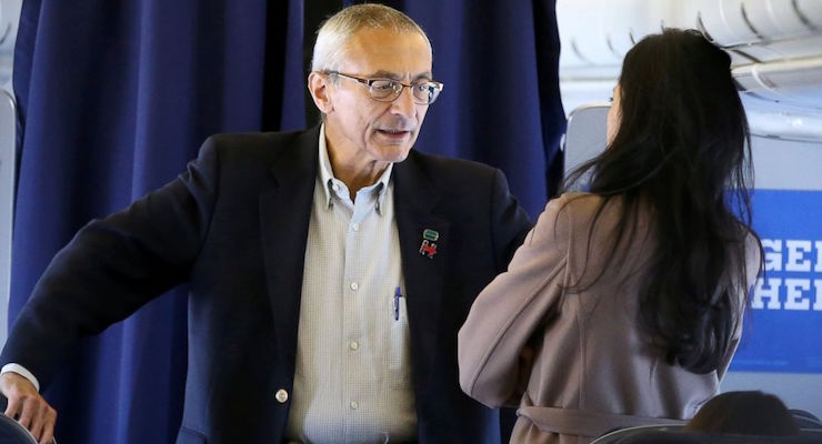 John Podesta, Campaign Manager, left, speaking to senior advisor Huma Abedin on the Hillary Clinton campaign plane from New York enroute to Miami, October 11, 2016. (Photo: Lucy Nicholson/REUTERS)