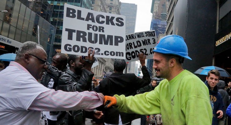 A construction worker exchanges a fist bump with pro-Trump supporters who gathered to cheer his election as President, Nov. 9, 2016, outside Trump Tower in New York. (Photo: AP/Associated Press)