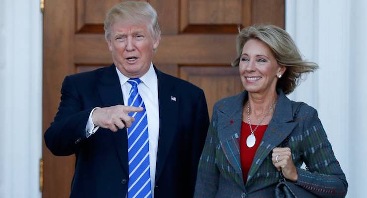 President-elect Donald Trump calls out to the media as he and Betsy DeVos pose for photographs at Trump National Golf Club Bedminster clubhouse in Bedminster, N.J., Saturday, Nov. 19, 2016. (Photo: AP)