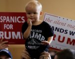 An adorable child is held up before Republican presidential nominee Donald Trump attends a campaign rally in at the Florida State Fairgrounds in Tampa, Florida, on November 5, 2016. (Photo: REUTERS/Carlo Allegri)