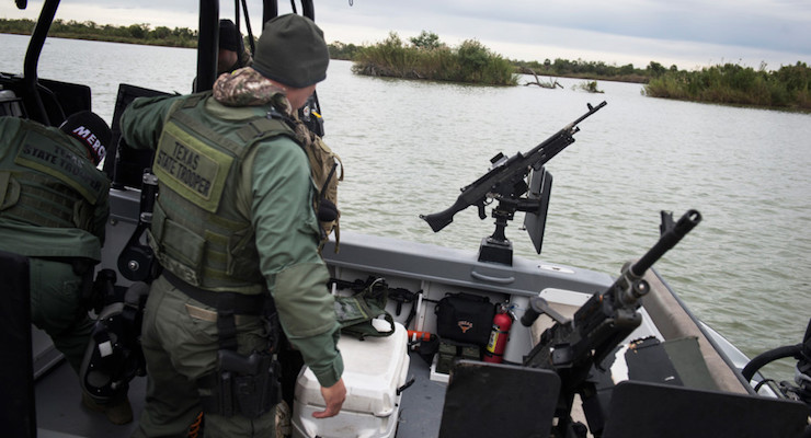 Texas state troopers prepare to launch a gun boat into the Rio Grande that separates the U.S. from Mexico in McAllen, Texas, on Tuesday, November 25, 2014. The troopers patrol the river all day to catch illegal immigrants attempting to cross the border.