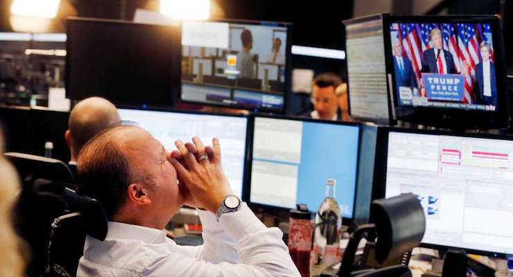 A broker reacts as the newly elected U.S. President Donald Trump shows up on a television screen at the stock market in Frankfurt, Germany. (Photo: AP)