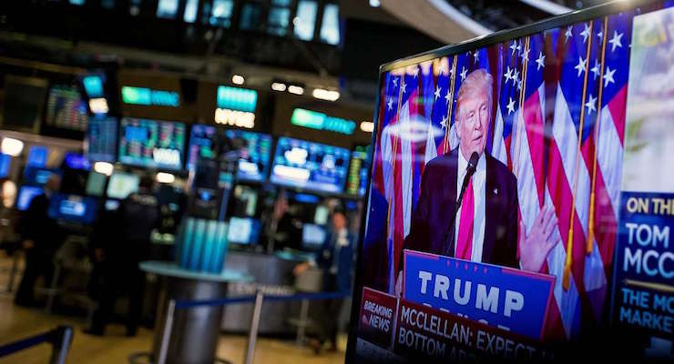 U.S. President-elect Donald Trump is seen speaking on a television on the floor of the New York Stock Exchange (NYSE) in New York, U.S., on Wednesday, Nov. 9, 2016. U.S. stocks fluctuated in volatile trading in the aftermath of Trump's surprise presidential election win, as speculation the Republican will pursue business-friendly policies offset some of the broader uncertainty surrounding his ascent. Photographer: Michael Nagle/Bloomberg