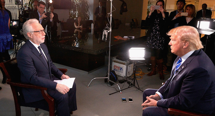 Wolf Blitzer, left, and Republican presidential candidate Donald Trump sit for an interview in which the Democratic National Committee designed and planted the questions for the "anchor" to pose.