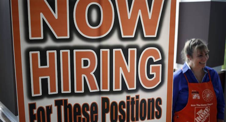 An employee at Home Depot (NYSE:HD) beyond a now hiring sign at a satellite location. (Photo: Reuters)