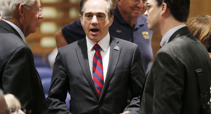 FILE - In this Dec. 14, 2015, file photo, U.S. Department of Veterans Affairs for Health Undersecretary Dr. David Shulkin, center, talks with attendees prior to testifying about the current state of the VA Medical Center in Phoenix at a Senate Veterans' Affairs Committee field hearing in Gilbert, Ariz. (Photo: AP)