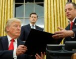 President Donald J. Trump, left, hands Chief of Staff Reince Priebus, right, an executive order in the Oval Office in Washington, Friday. (Photo: Reuters)