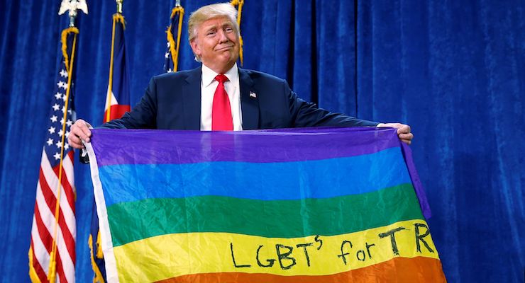 Then-presidential candidate Donald J. Trump holds up a rainbow flag with LGBTs for Trump written on it at a rally in Greeley, Colorado. (Photo: Reuters)