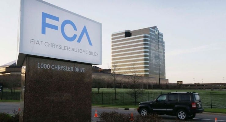 In this photo taken on Tuesday, May 6, 2014, a vehicle drives past a sign outside the Fiat Chrysler Automobiles world headquarters in Auburn Hills, Michigan. (Photo: AP)