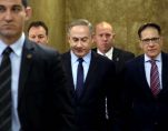 Israeli Prime Minister Benjamin Netanyahu, center, arrives for a weekly cabinet meeting, in Jerusalem, Sunday, Jan. 1, 2017. (Photo: AP)