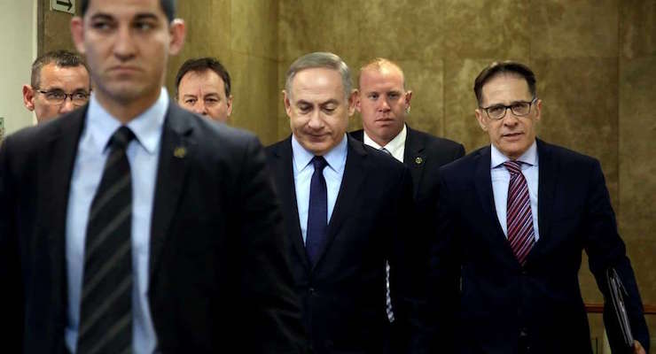 Israeli Prime Minister Benjamin Netanyahu, center, arrives for a weekly cabinet meeting, in Jerusalem, Sunday, Jan. 1, 2017. (Photo: AP)