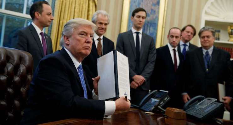 President Donald Trump shows his signature on an executive order in the Oval Office in Washington. (Photo: AP)