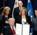 President Donald J. Trump, center, sits to the left of Vice President Mike Pence, to the right of Homeland Security Secretary John F. Kelly, while holding up an executive order to build border wall and fulfill other campaign promises related to immigration. The orders were signed at the U.S. Department of Homeland Security on Wednesday, Jan. 25, 2017 in Washington. (Photo: AP)