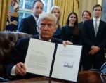 President Donald Trump shows his signature on an executive order on the Keystone XL pipeline, Tuesday, Jan. 24, 2017. (Photo: AP)