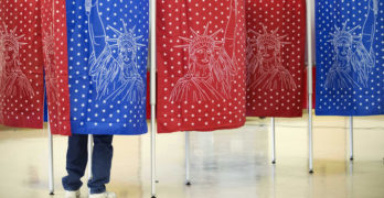 A voter marks a ballot for the New Hampshire primary Feb. 9 inside a voting booth at a polling place in Manchester, N.H. (Photo: AP)