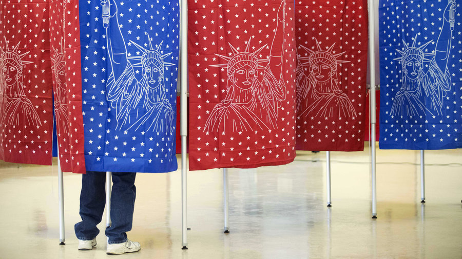 A voter marks a ballot for the New Hampshire primary Feb. 9 inside a voting booth at a polling place in Manchester, N.H. (Photo: AP)