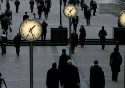 Pedestrians walk through the Canary Wharf financial district of London January 16, 2009.