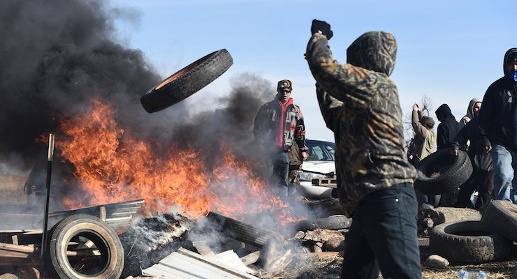 Protesters built barricades and set them ablaze as heavily armed police approached the protest camp.
