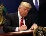 President Donald J. Trump signs an executive order to impose tighter vetting of travelers entering the United States on January 27, 2017. (Photo: Reuters)
