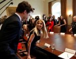 Canadian Prime Minister Justice Trudeau, left, Ivanka Trump, to his right, and President Donald J. Trump, right to back of room, greet before a roundtable discussion on women business leaders.