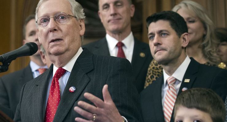 House Speaker Paul Ryan of Wisconsin and others listen as Senate Majority Leader Mitch McConnell of Kentucky speaks on Capitol Hill in Washington on Dec. 8, 2016.