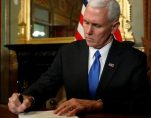 U.S. Vice President Mike Pence signs a document in his ceremonial office in the Eisenhower Executive Office Building at the White House in Washington, Jan. 20, 2017. (Photo: Reuters)