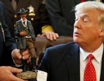 President Donald J. Trump receives a figurine of a sheriff during a meeting with county sheriffs at the White House. (Photo: Reuters)