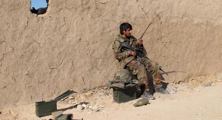 An Afghan National Army (ANA) soldier speaks on a radio at an outpost in Helmand province, December 20, 2015. (Photo: Reuters)