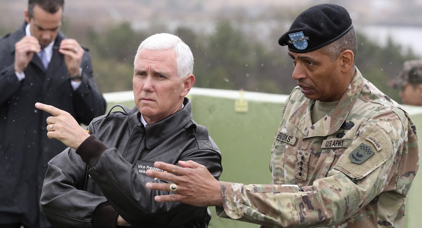 Vice President Mike Pence is briefed by Gen. Vincent Brooks, commander of the United Nations Command, U.S. Forces Korea and Combined Forces Command, from Observation Post Ouellette in the demilitarized zone (DMZ), near the border village of Panmunjom, South Korea, on Monday. (Photo: AP)