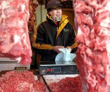 In this Jan. 22, 2003 file photo, a Chinese shopkeeper stands behind a row of beef products at an open air market in Beijing, China. China will finally open its borders to U.S. beef while cooked Chinese poultry is closer to hitting the American market as part of a U.S.-China trade agreement. Trump administration officials hailed the deal as a significant step in their efforts to boost U.S. exports and even America's trade gap with the world's second-largest economy. (Photo: AP)