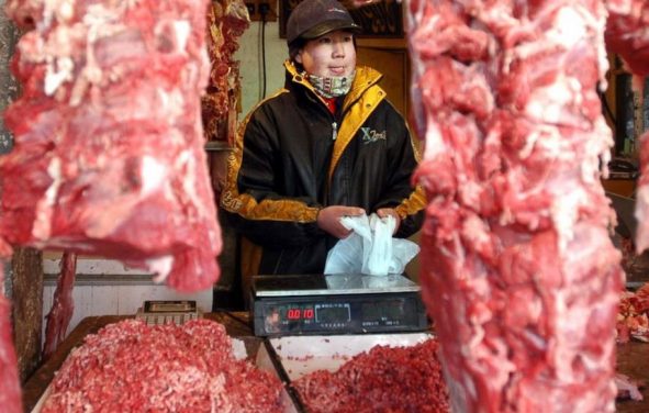 In this Jan. 22, 2003 file photo, a Chinese shopkeeper stands behind a row of beef products at an open air market in Beijing, China. China will finally open its borders to U.S. beef while cooked Chinese poultry is closer to hitting the American market as part of a U.S.-China trade agreement. Trump administration officials hailed the deal as a significant step in their efforts to boost U.S. exports and even America's trade gap with the world's second-largest economy. (Photo: AP)