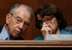 Sen. Dianne Feinstein, D-Calif., whispers something into the ear of her colleague Sen. Chuck Grassley, R-Ia., during a Senate hearing. (Photo: AP)