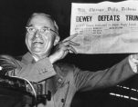 Incumbent President Harry Truman holds up a Chicago Tribune headline stating that he had been defeated by Thomas E. Dewey, the Republican candidate in the 1948 presidential election.