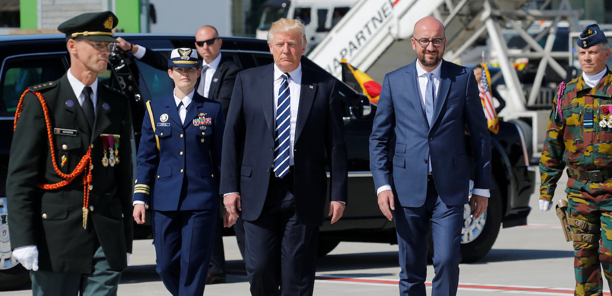 U.S. President Donald Trump walks beside Belgium's Prime Minister Charles Michel (R) upon arriving at the Brussels Airport, in Brussels, Belgium, May 24, 2017. (Photo: Reuters)