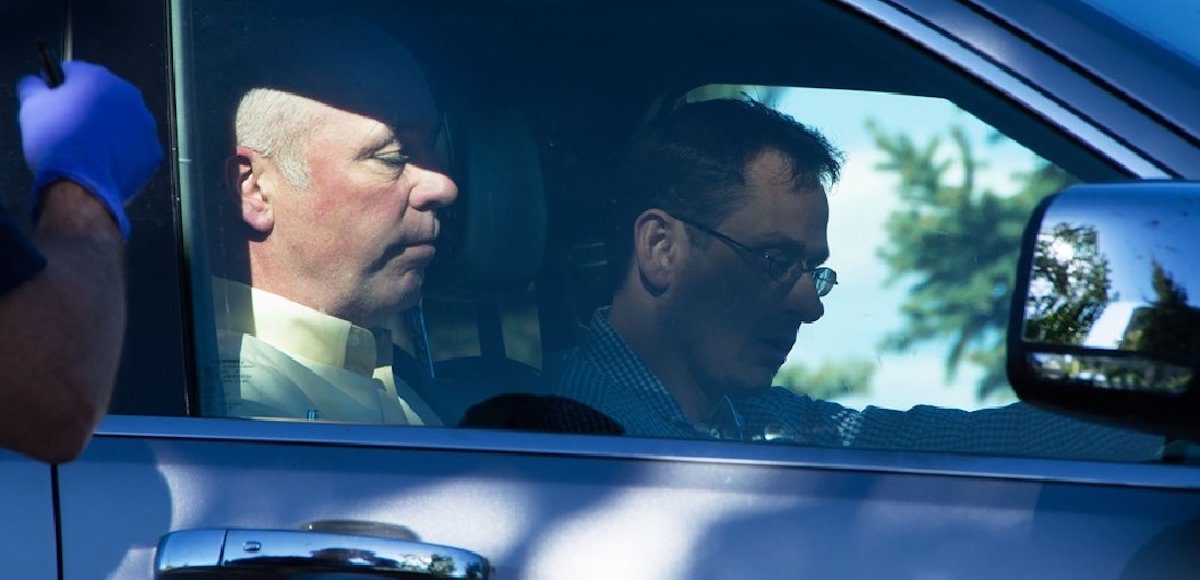 Montana Republican candidate Greg Gianforte sits in a car.