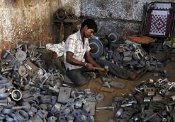 A worker separates casting joints of gearboxes inside a small-scale automobile manufacturing unit in Ahmedabad, India, October 12, 2015. (Photo: Reuters)
